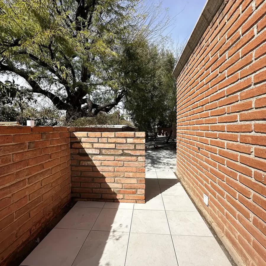 Close-up of clay brick masonry meeting new porcelain paving