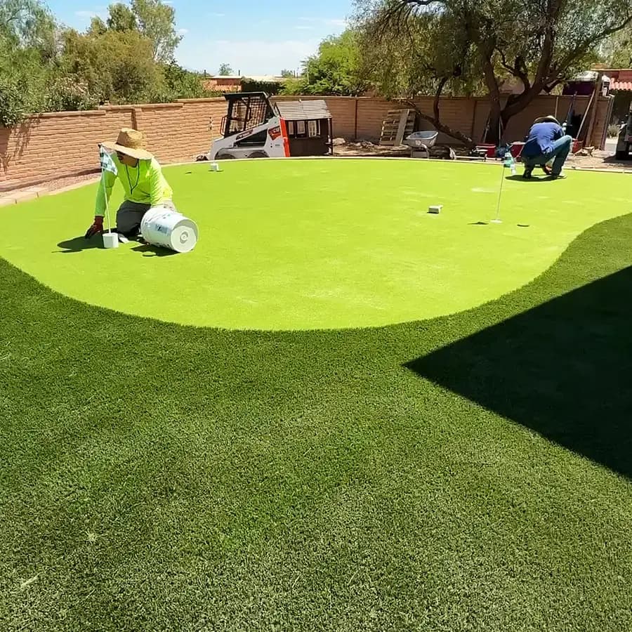 Close-up of artificial turf blades on a finished Tucson lawn